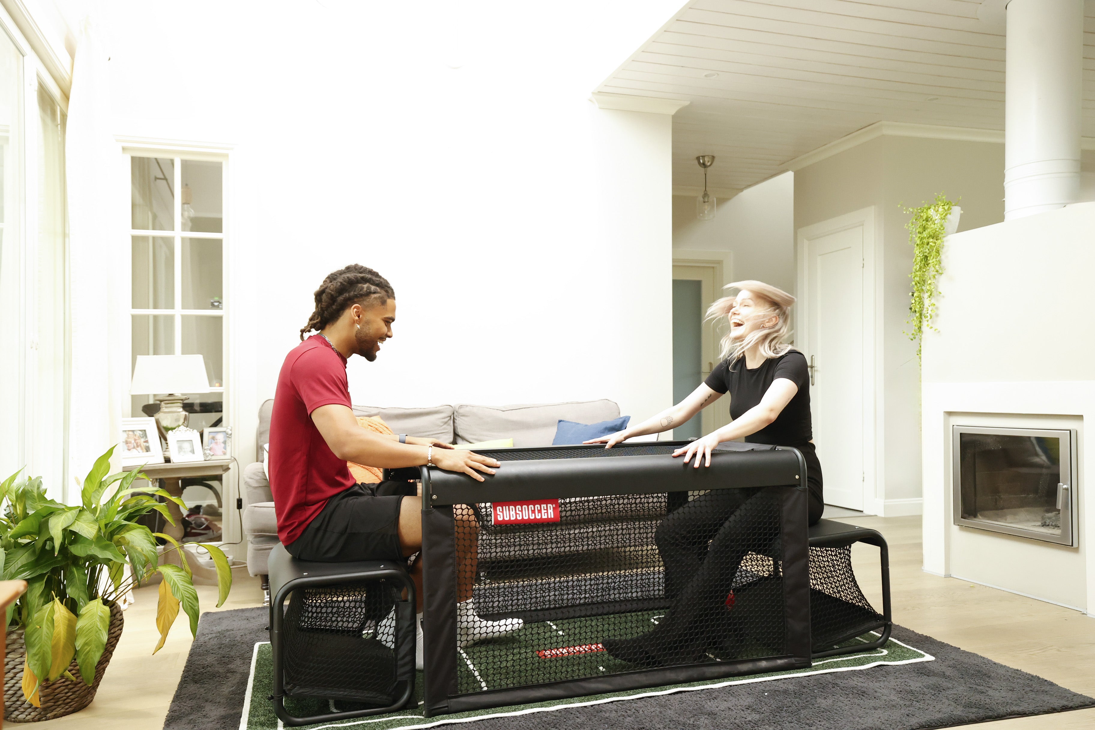 SubSoccer S7 bench soccer game being played in a bright home interior with large windows