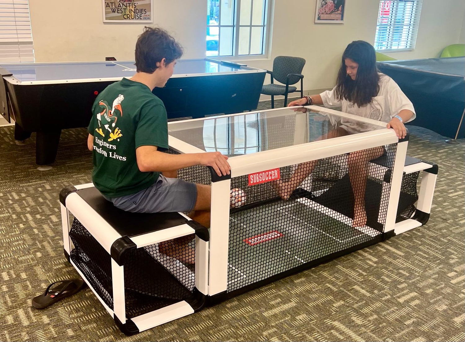 Person playing the SubSoccer S7 bench soccer table in pearl white at home